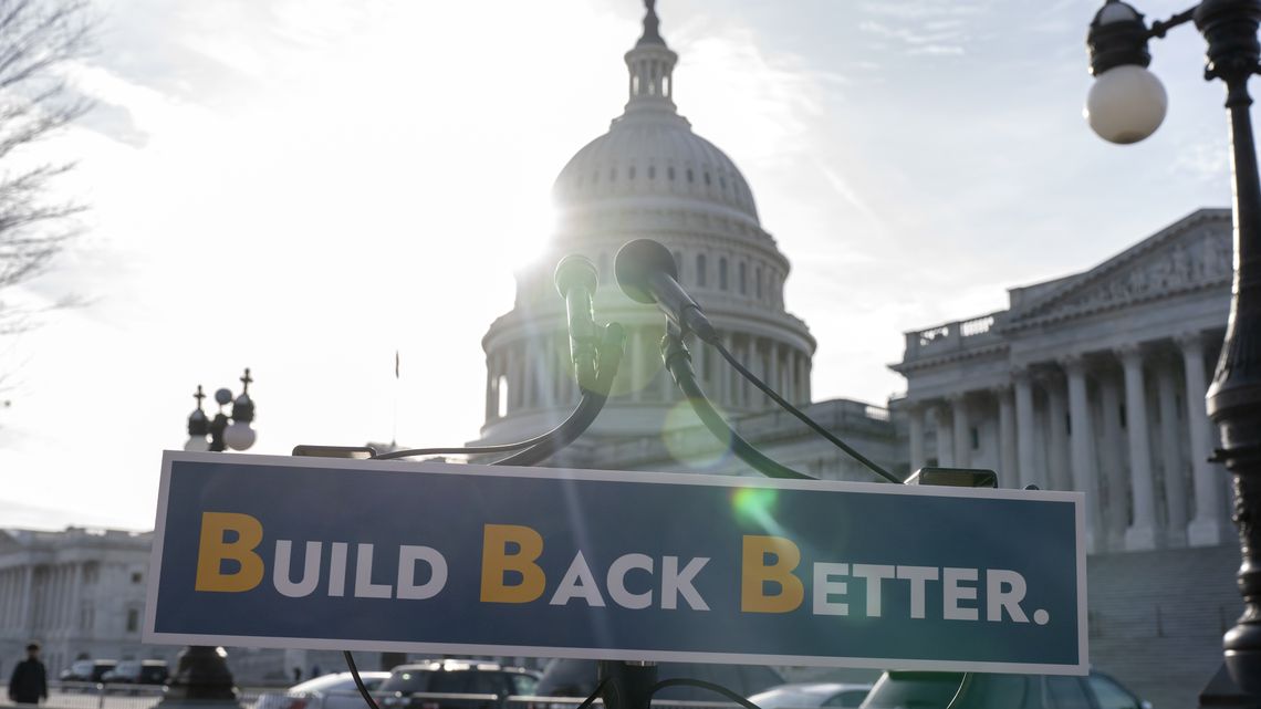 With the U.S. Capitol dome in the background, a sign that reads "Build Bake Better" is displayed before a news conference, Wednesday, Dec. 15, 2021, on Capitol Hill in Washington. (AP Photo/Jacquelyn Martin) [ JACQUELYN MARTIN | AP ]