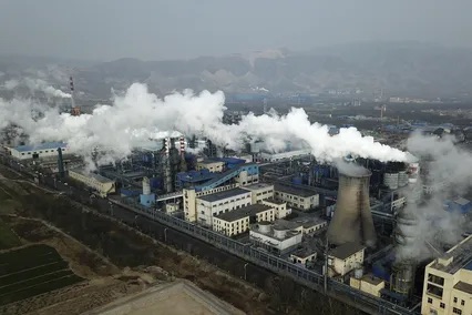 Smoke and steam rise from a coal processing plant in Hejin in central China's Shanxi Province. [ SAM MCNEIL | AP ]